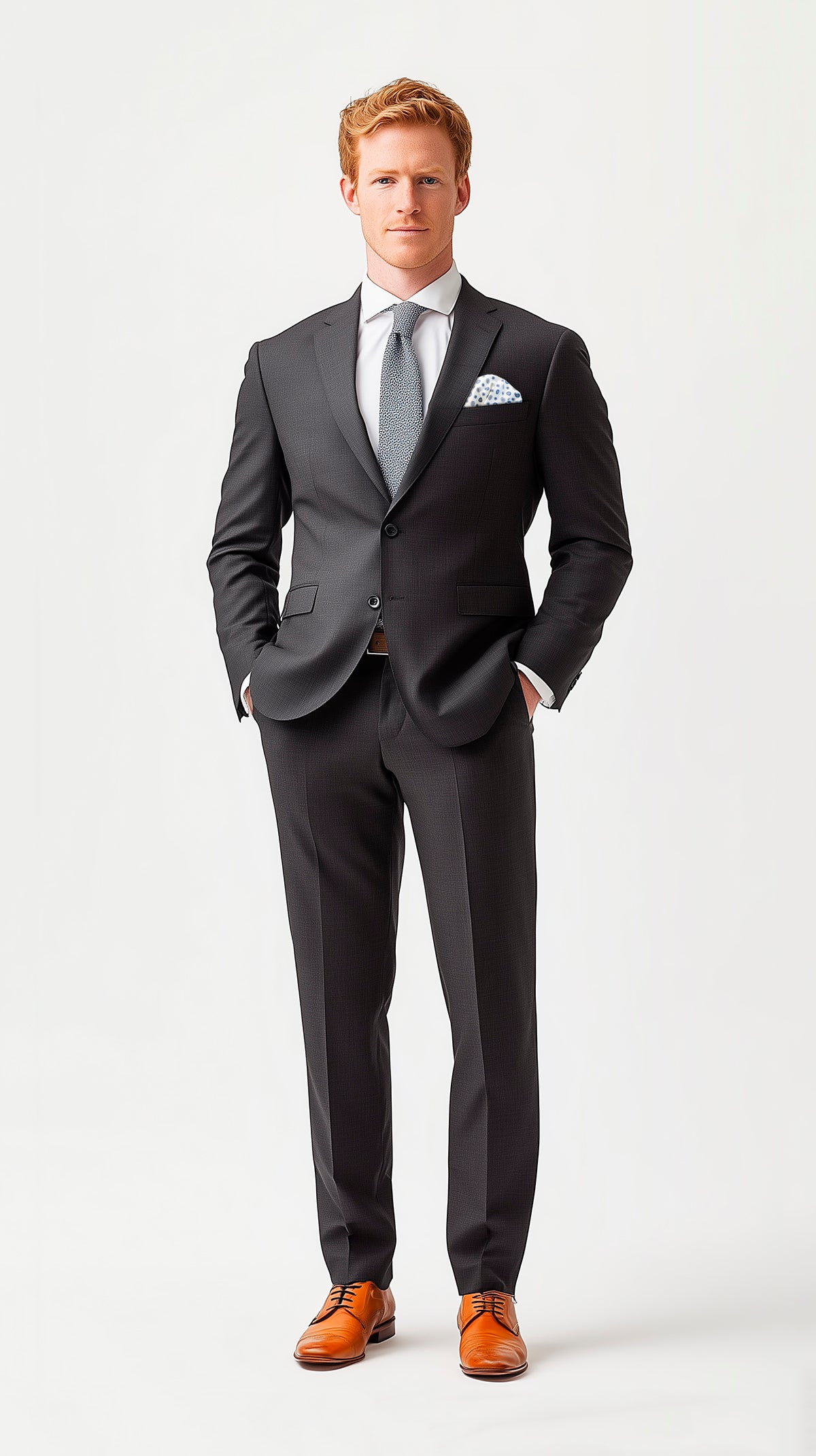 Man in gray classic fit suit and tan leather shoes wearing a mint and pink pocket square puff fold
