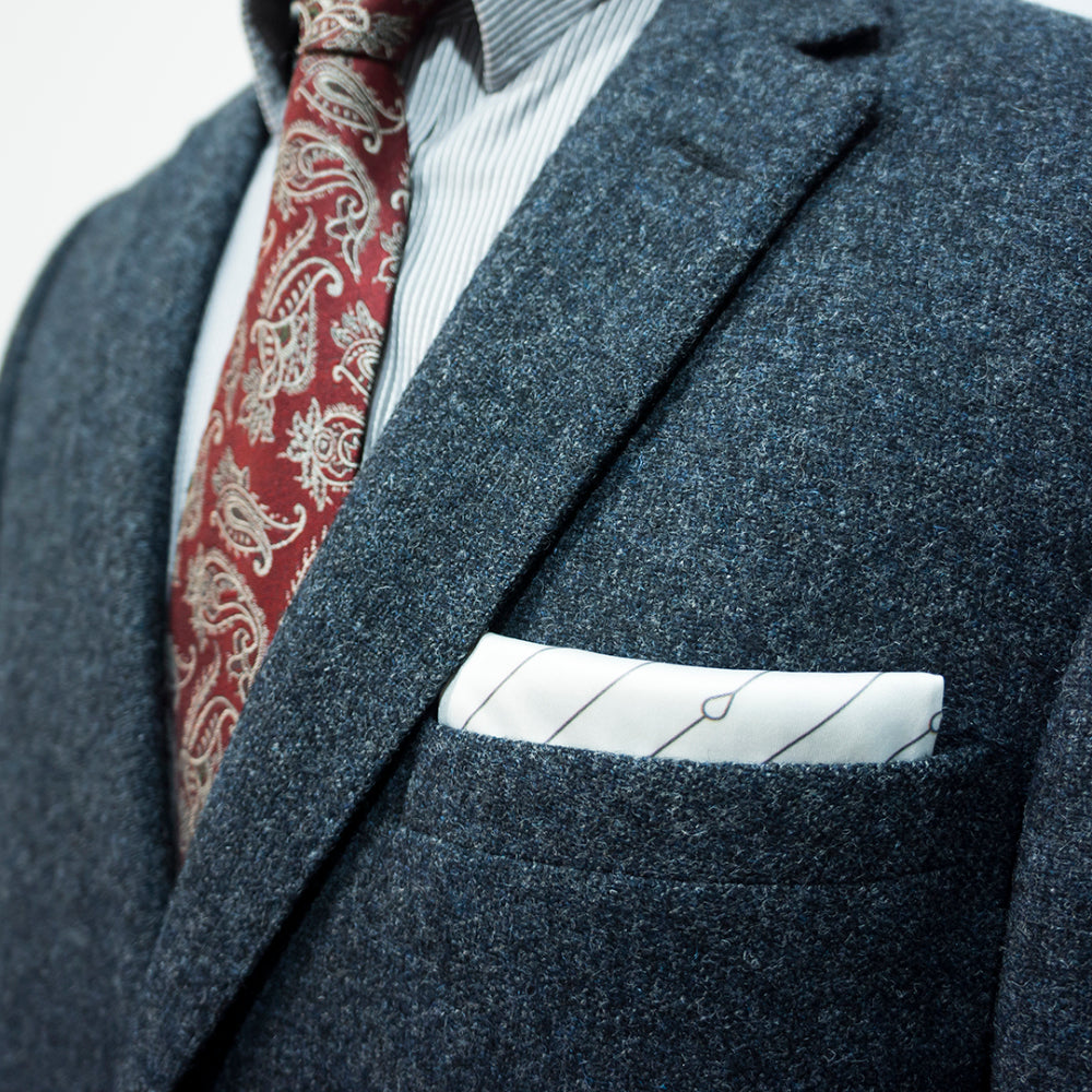 Dark gray suit with maroon paisley tie and white TV-fold pocket square
