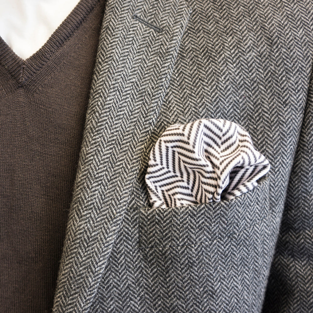 Herringbone patterned pocket square in herringbone tweed jacket pocket