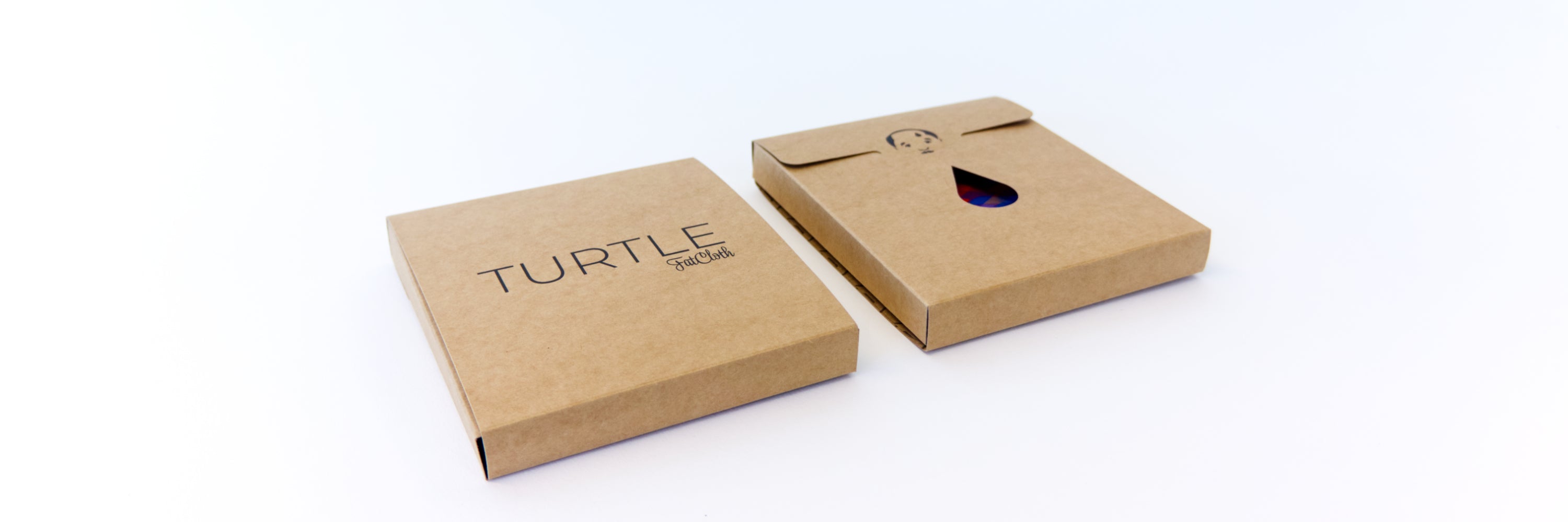 Two FatCloth brown Kraft cardboard boxes on white background