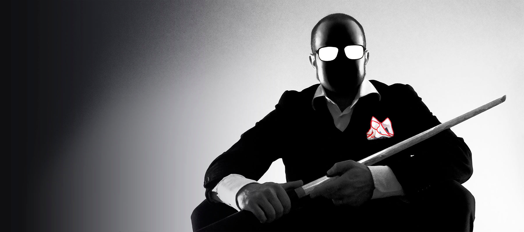 Black and white Sin City styled image of a man wielding a Katana and wearing a black suit with white pocket square
