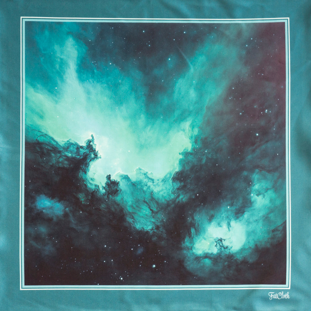 A multipurpose pocket square featuring a space-themed nebula print in vibrant teal, black, and white, framed by a thin white border on a matching teal fabric background.