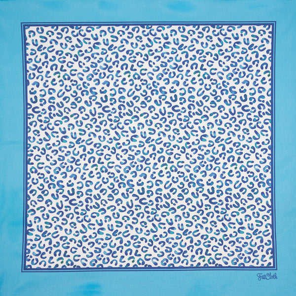 Knut multipurpose pocket-handkerchief by FatCloth depicts imaginary animal print in tones of blue and pale 