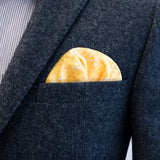 The bright high-contrast design of FatCloth Manuel Yellow pocket square really jumps out of dark suit pockets