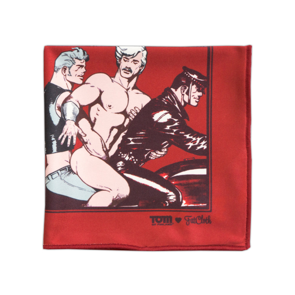 Pocket square red fabric with graphic design of three figures on motorbike, featuring FatCloth x Tom brand name at the bottom.