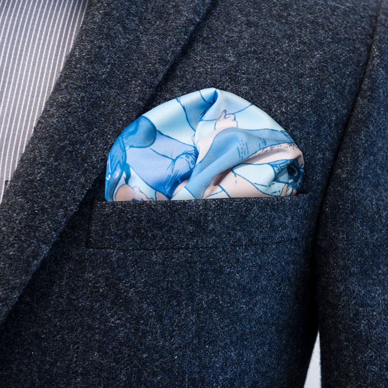 Blue colours of FatCloth Pekka pocket square complement especially well brown and light gray attires
