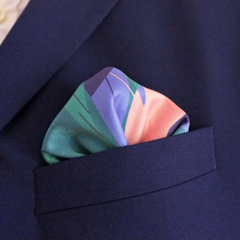 Dark blue pocket works as a good contrast for FatCloth Oula pocket square with peach and teal details